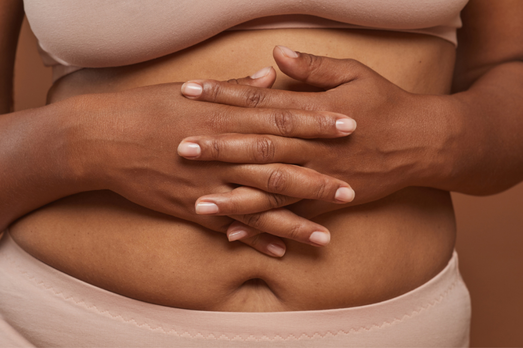 a black woman holding her belly
