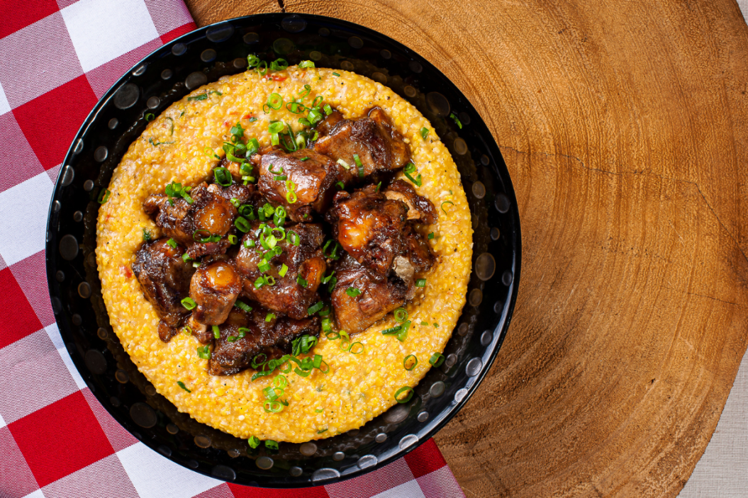 oxtails in grits in a bowl