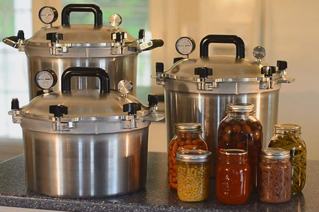 pressure canners with jars of canned goods